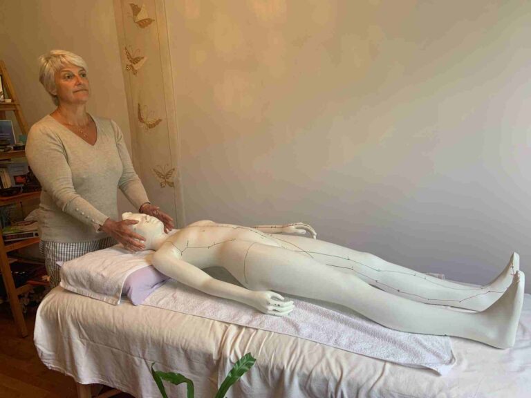 Cécile Thomas of Harmony Me practicing Reiki on a dummy during a distance Reiki session to help her client